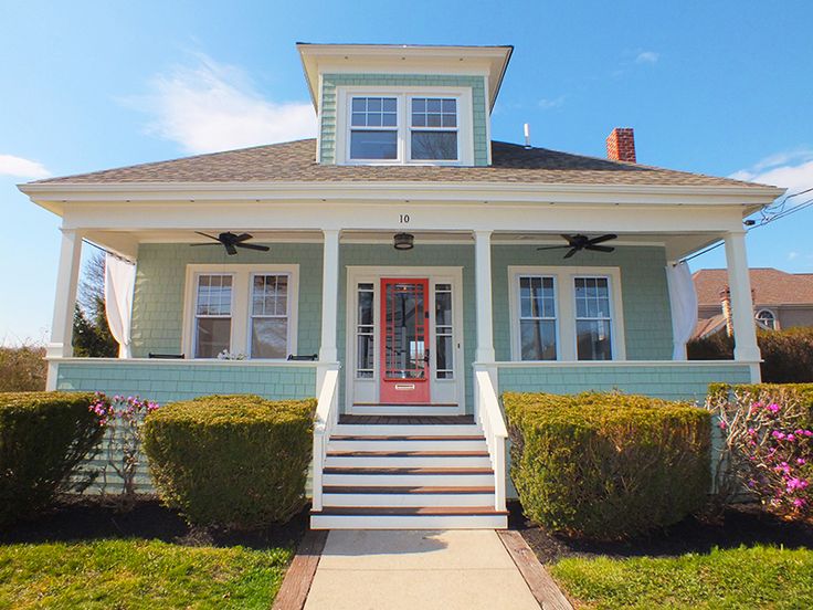 a blue house with white trim and red door