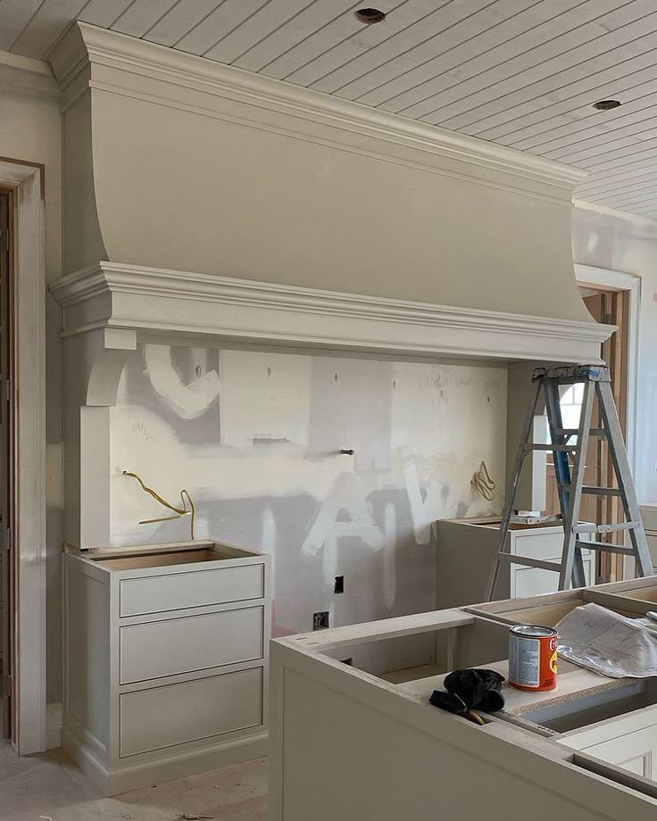 an unfinished kitchen is being painted white