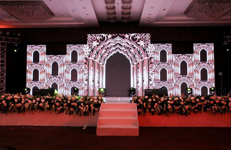 the stage is set up for an event with red carpeting and white lighting on it