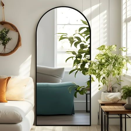 a living room filled with furniture and plants