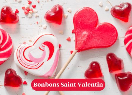 red and white lollipops with heart shaped candies around them on a table