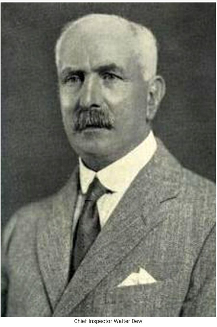 an old black and white photo of a man in a suit with a moustache