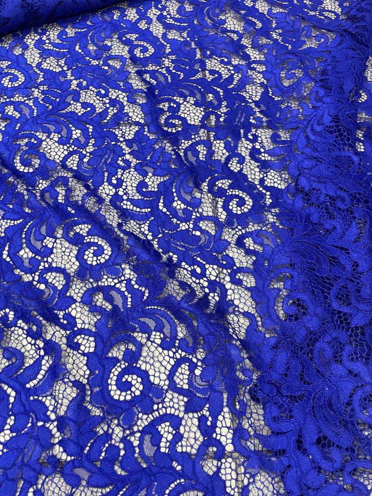 blue lace fabric with white flowers on it