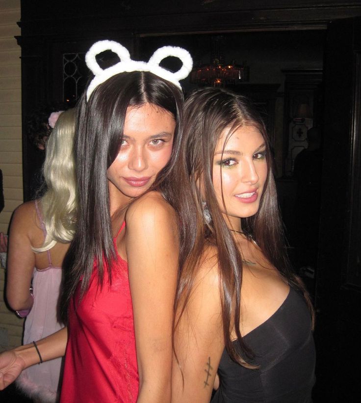 two young women standing next to each other wearing bunny ears on their headbands