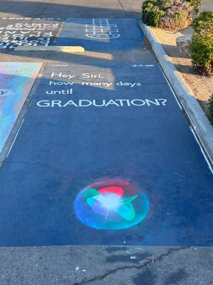 a sidewalk with chalk writing on it and an umbrella painted on the pavement