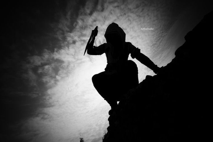 a person climbing up the side of a mountain with an ax in their hand,