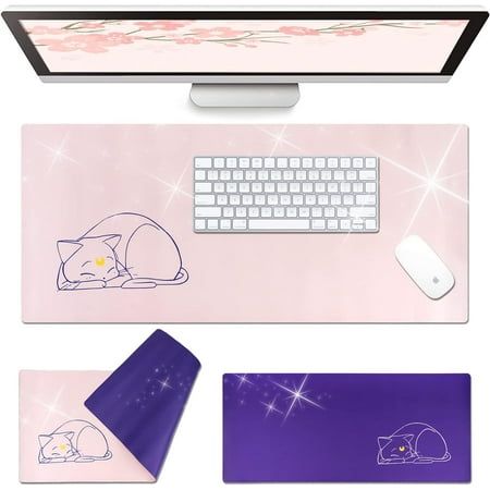 the mouse pad is next to a computer monitor and keyboard with a cat on it