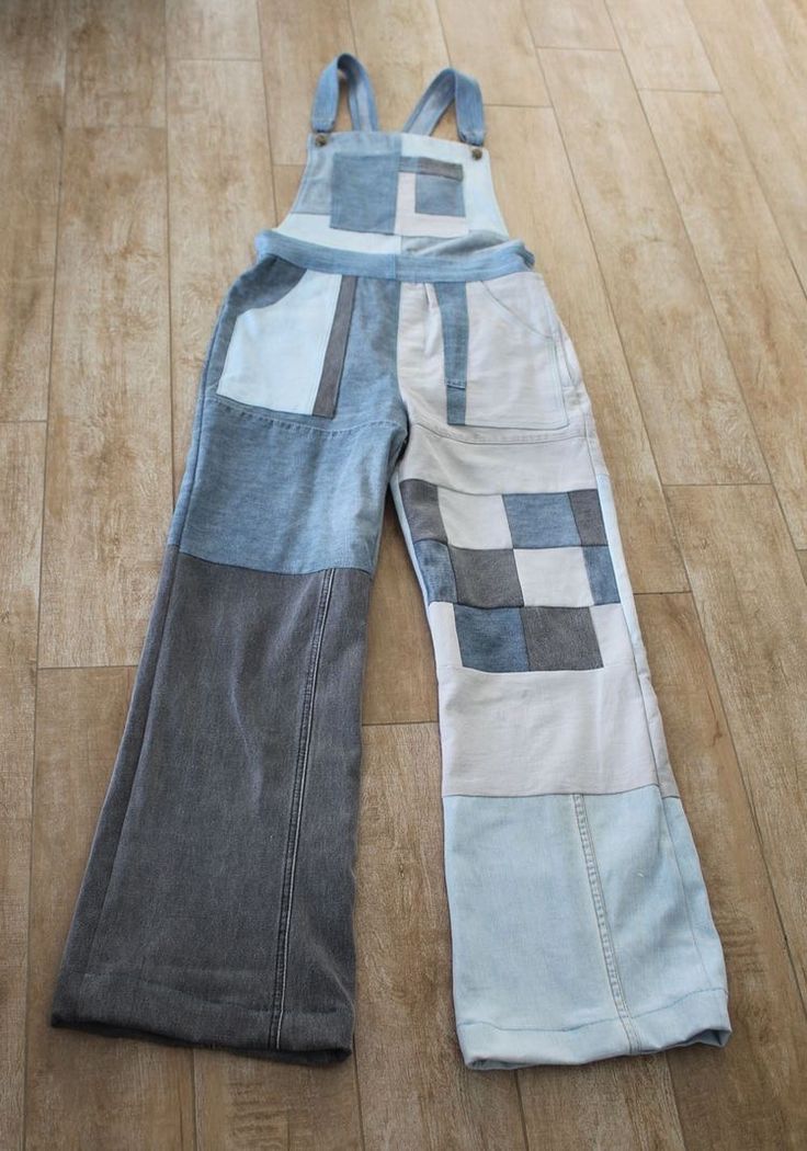 a pair of jeans laying on top of a wooden floor