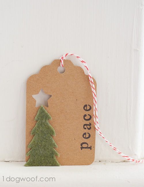 a tag that says peace with a small christmas tree on the front and side of it