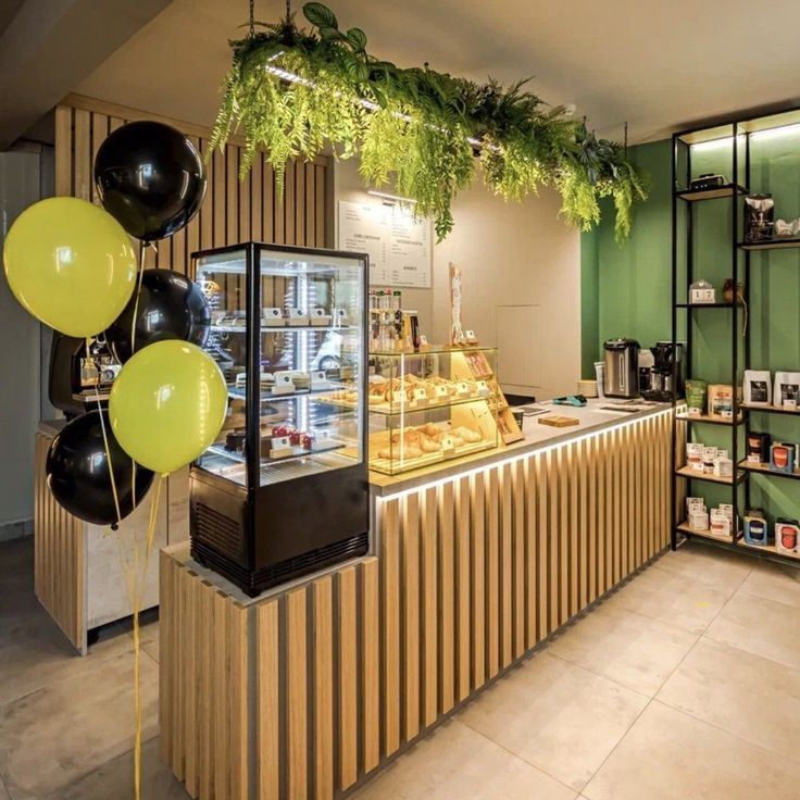 a bakery with green walls and balloons hanging from the ceiling