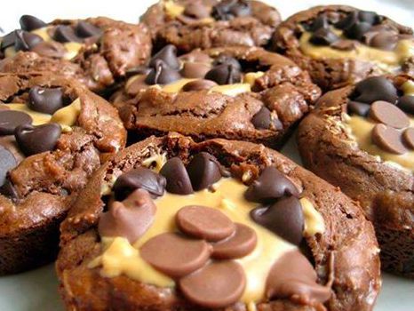 several cookies with chocolate chips and melted cheese on top are sitting on a white plate