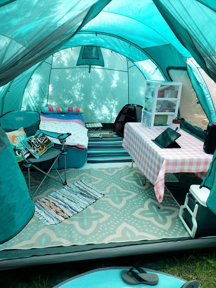 the inside of a tent with tables and chairs