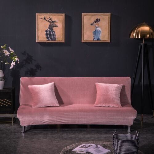 a living room with two paintings on the wall and a pink couch in front of it