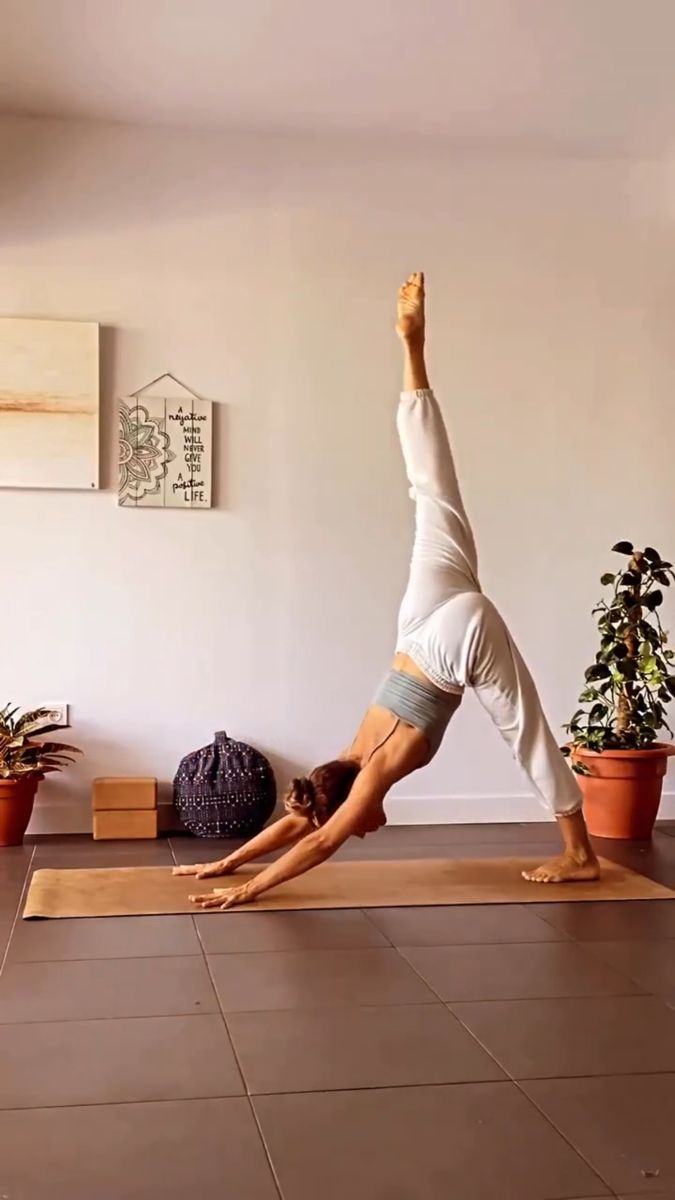 a woman is doing yoga on the floor