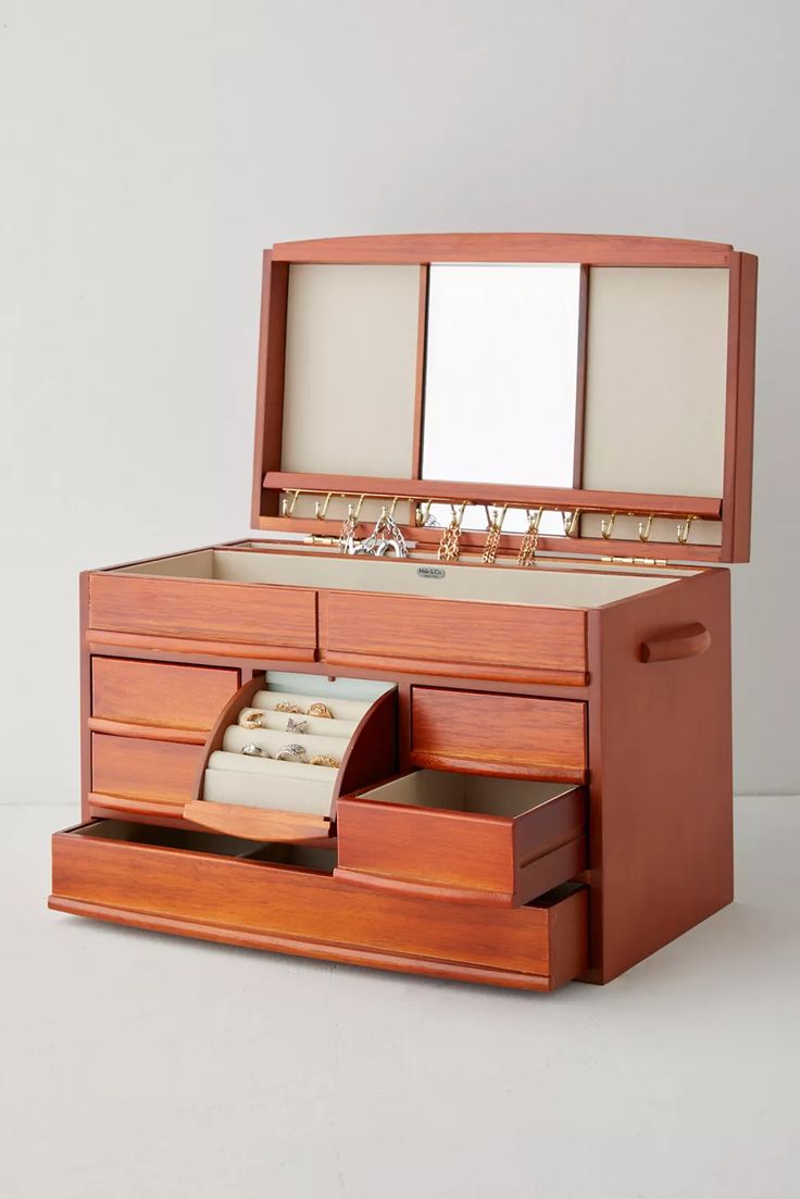 an open wooden jewelry box with two drawers