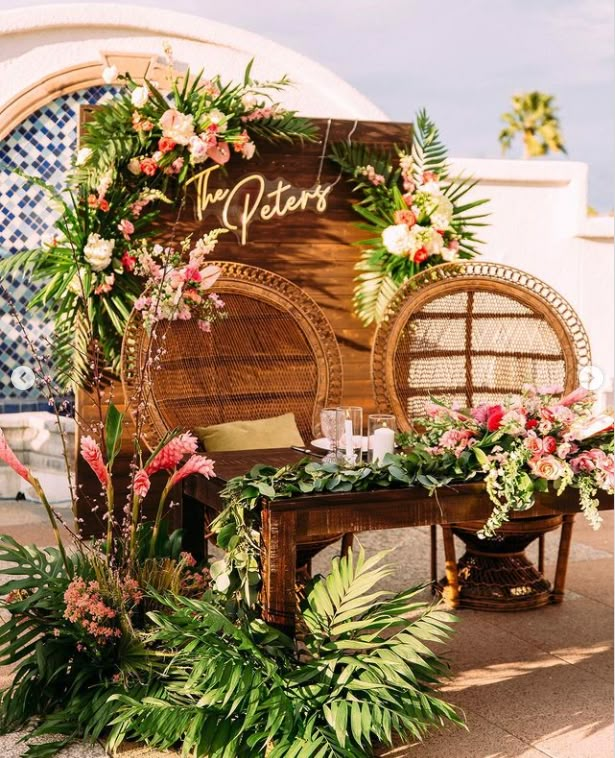 a wooden bench with flowers and greenery on it, next to a sign that says my destination