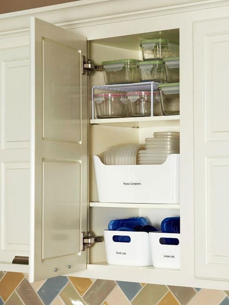 an open cabinet filled with dishes and containers