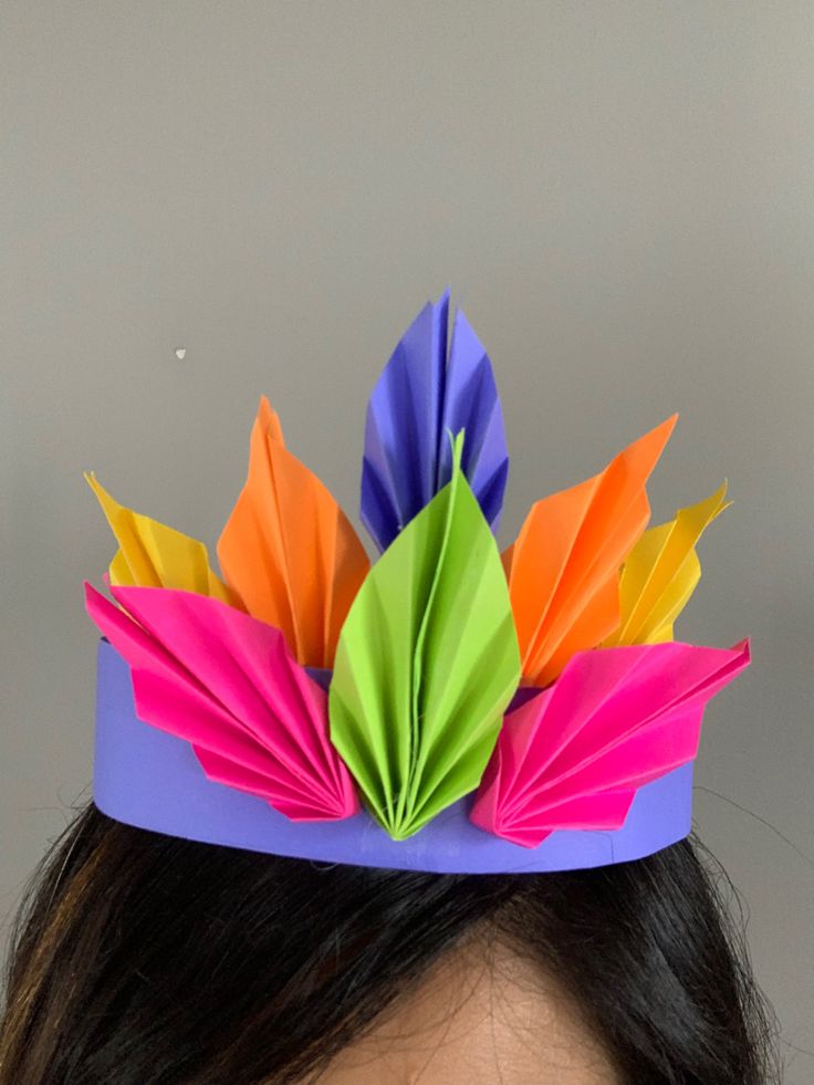 a woman wearing a colorful paper crown on her head