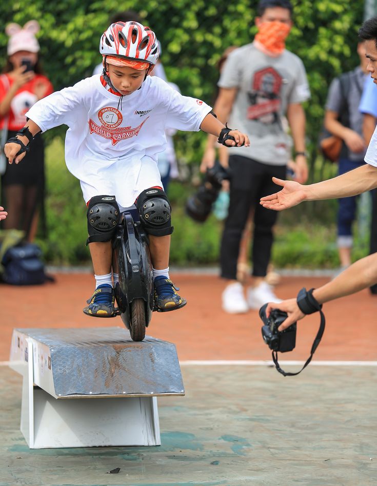 a young man riding a skateboard on top of a metal box