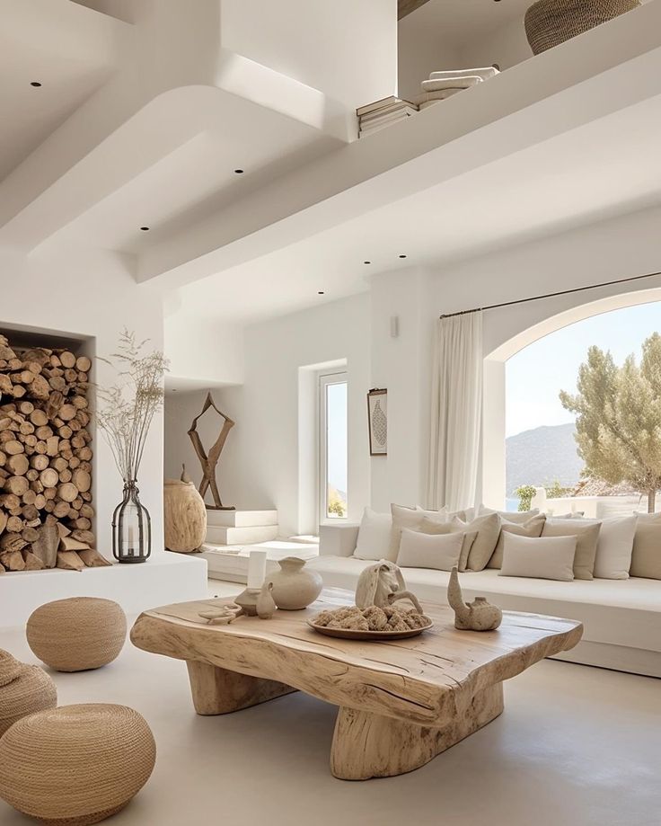 a living room filled with furniture and a firewood log wall behind the couches