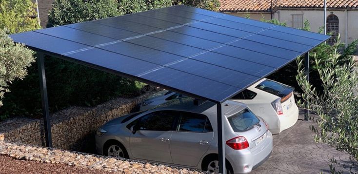 a car is parked under a solar panel