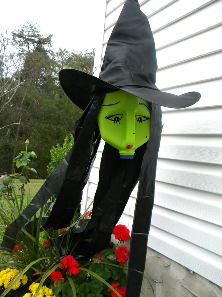 a plastic witch head sitting on top of a flower pot