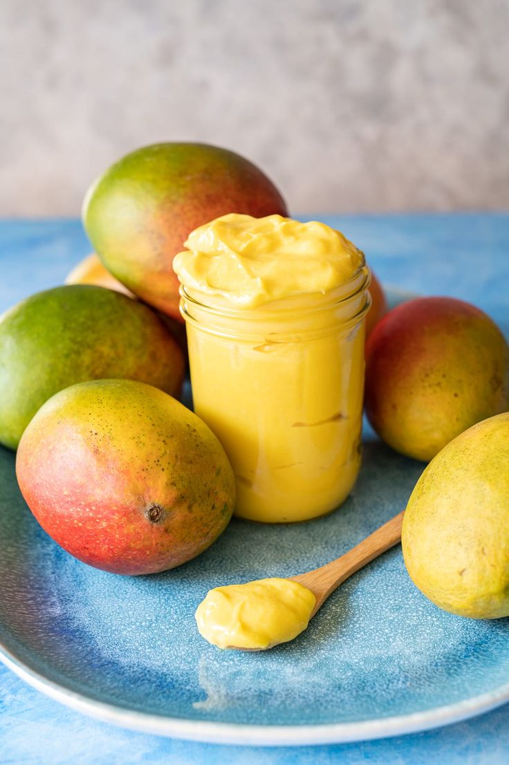 a plate with some mangoes and a jar of mayonnaise next to it