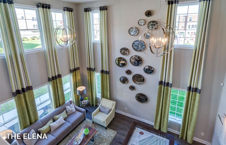 a living room filled with furniture and lots of windows