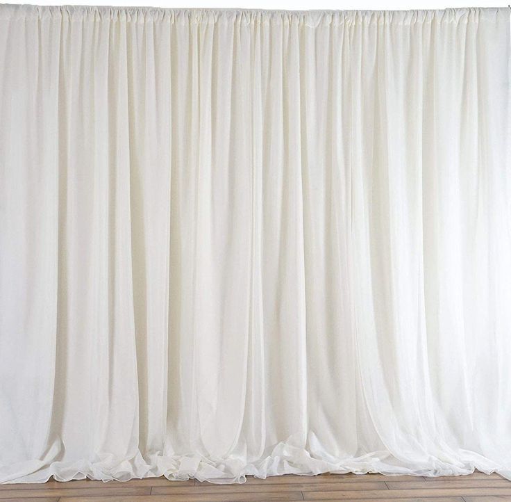 a white curtain is hanging on the wall