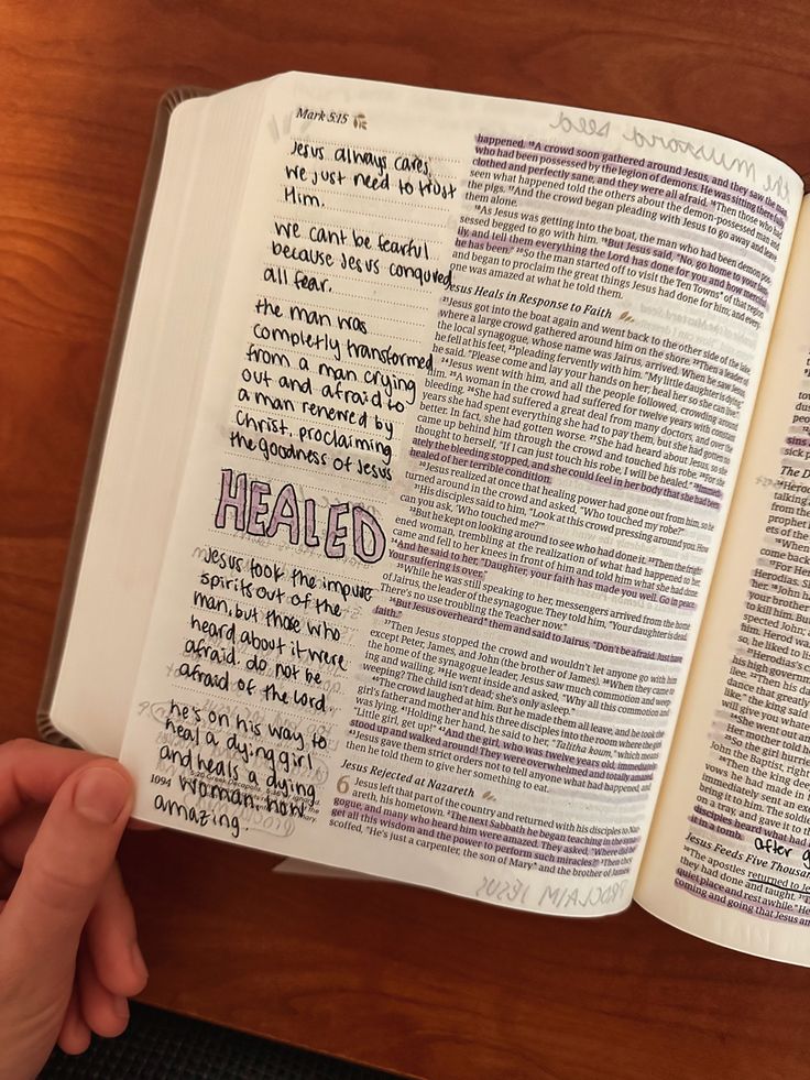 an open bible with the word healed written on it and someone holding their hand out