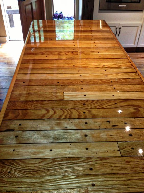 a wooden counter top in a kitchen next to an oven