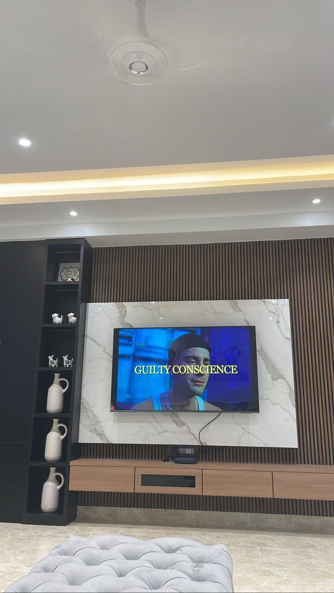 a flat screen tv mounted on the wall in a living room