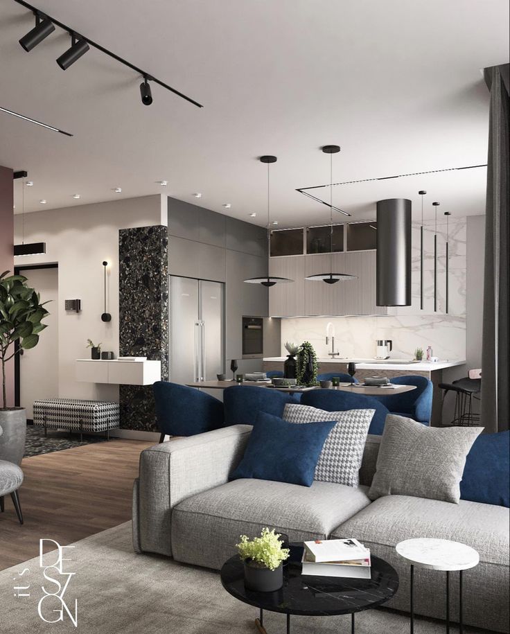 a living room filled with furniture next to a kitchen