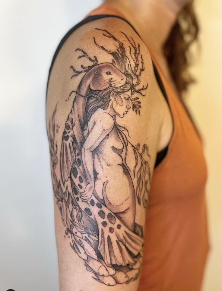 a woman with a tattoo on her arm