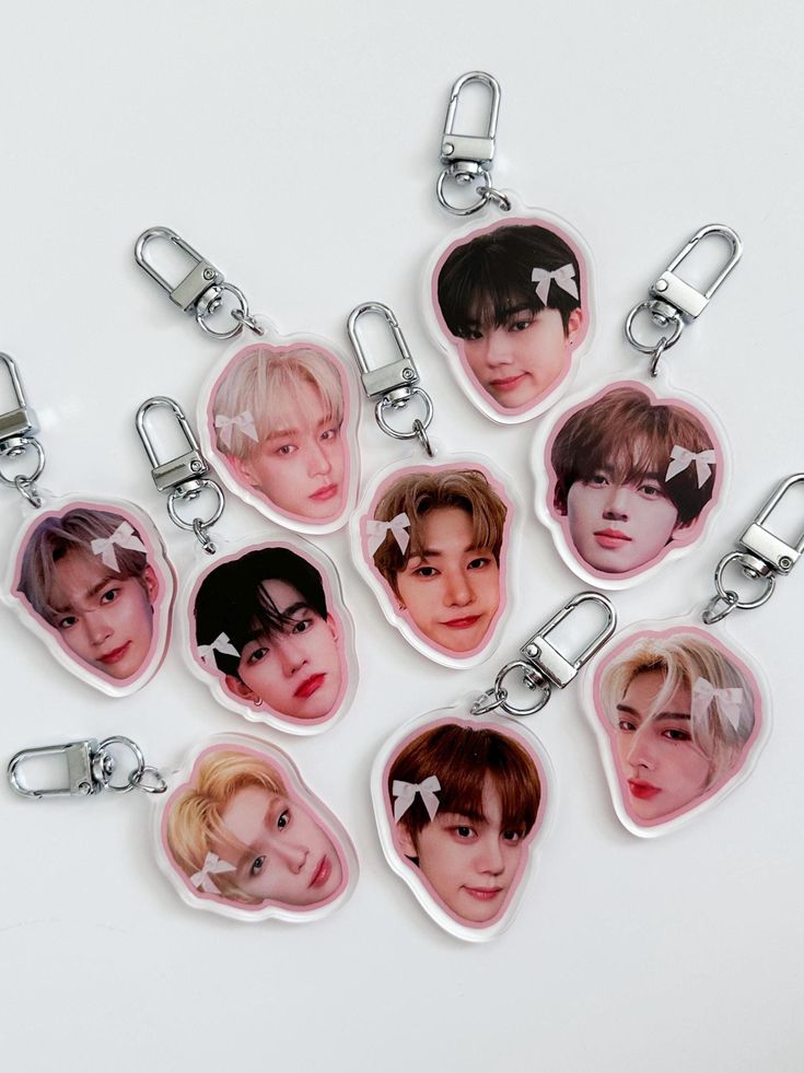 six keychains with the faces of bts members on them, all in different shapes and sizes