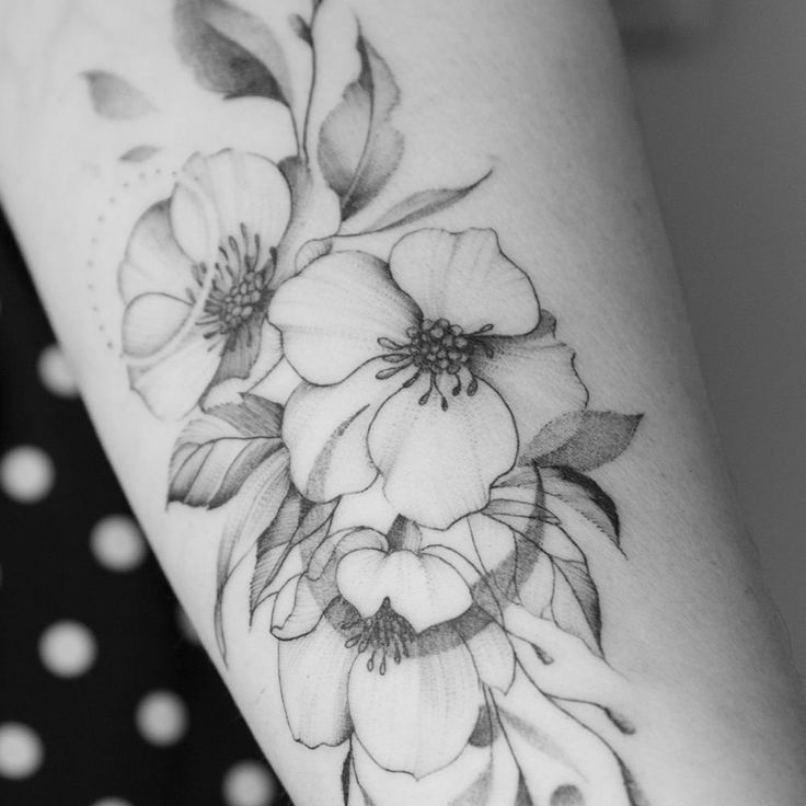 a woman's arm with flowers on it