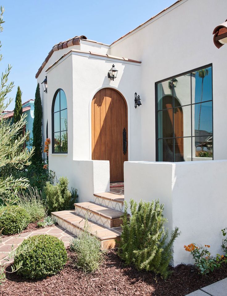 a white house with wooden doors and windows