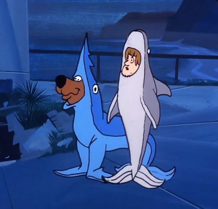 the shark and dog are standing next to each other in front of an ocean background