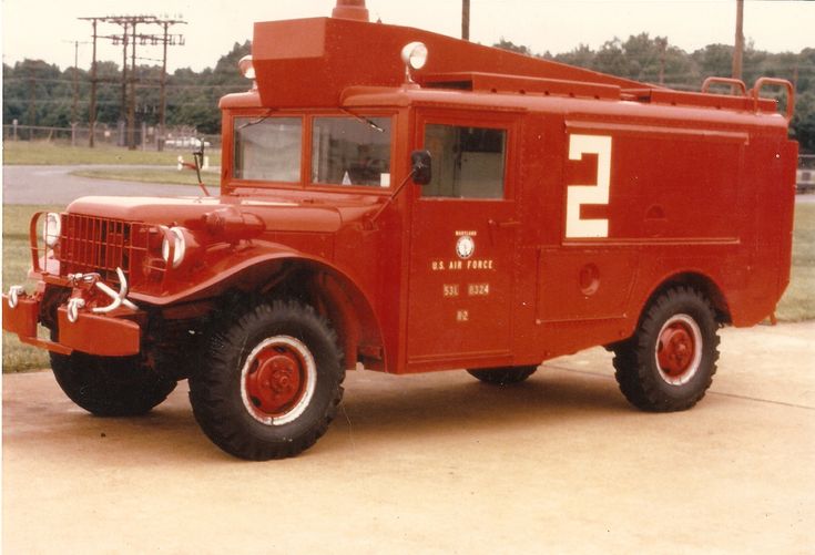 an old fire truck is parked on the street