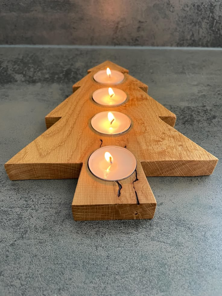 four candles are arranged in the shape of an arrow