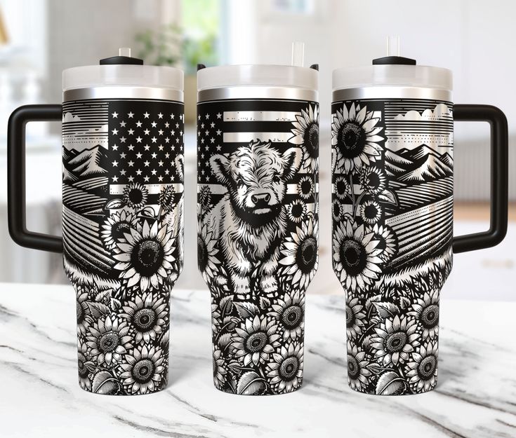 three travel mugs sitting on top of a marble counter next to an american flag