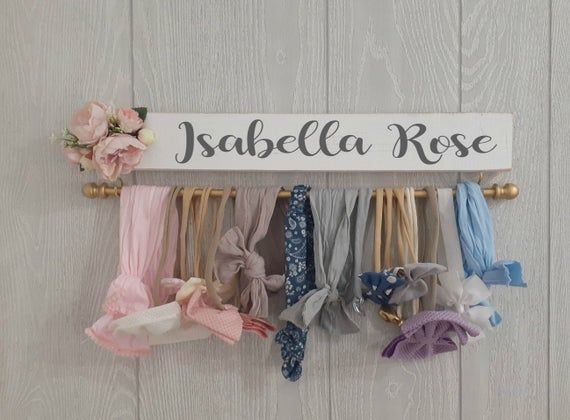 there is a sign that says jabella rose with many different bows hanging from it