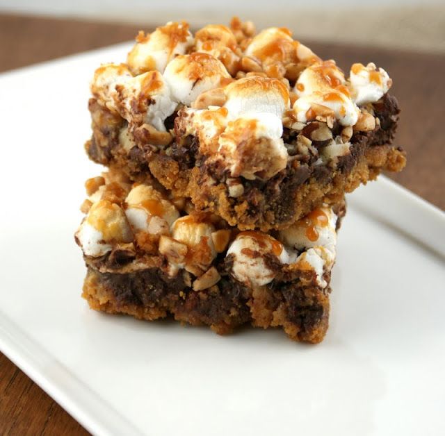 two pieces of dessert sitting on top of a white plate with marshmallows