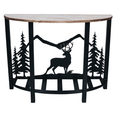 a metal table with a moose and trees on it