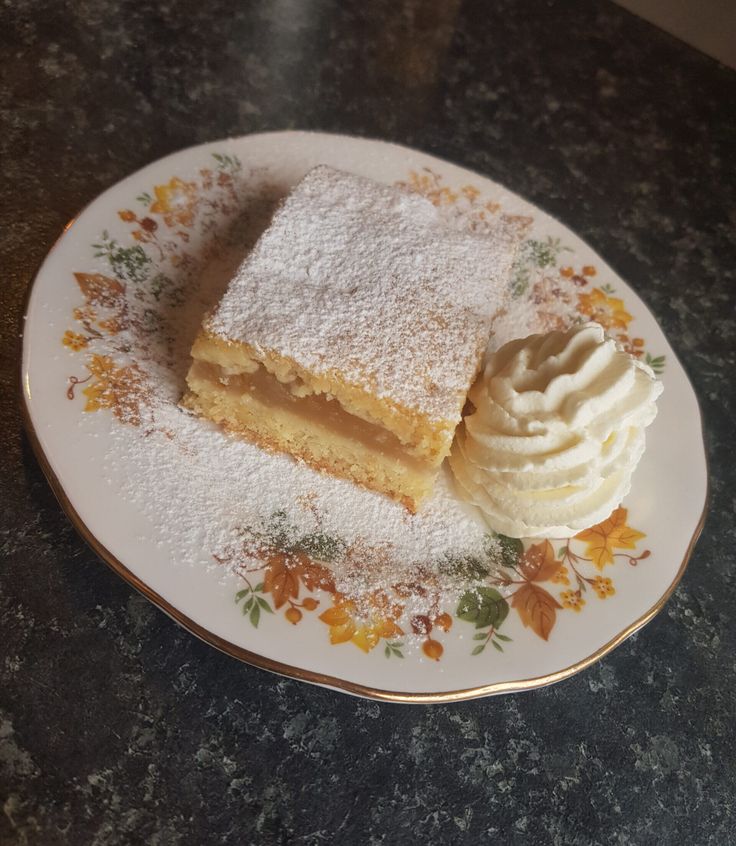 two pieces of cake on a plate with whipped cream