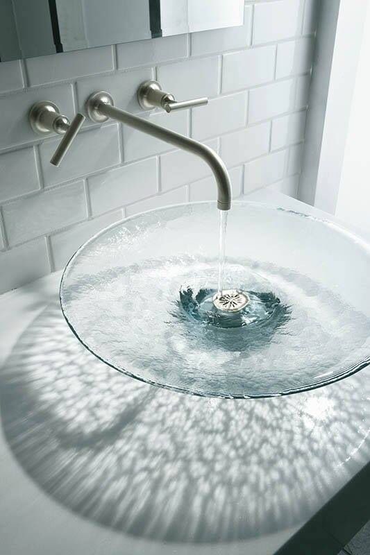 a bathroom sink with water running from it's faucet to the side