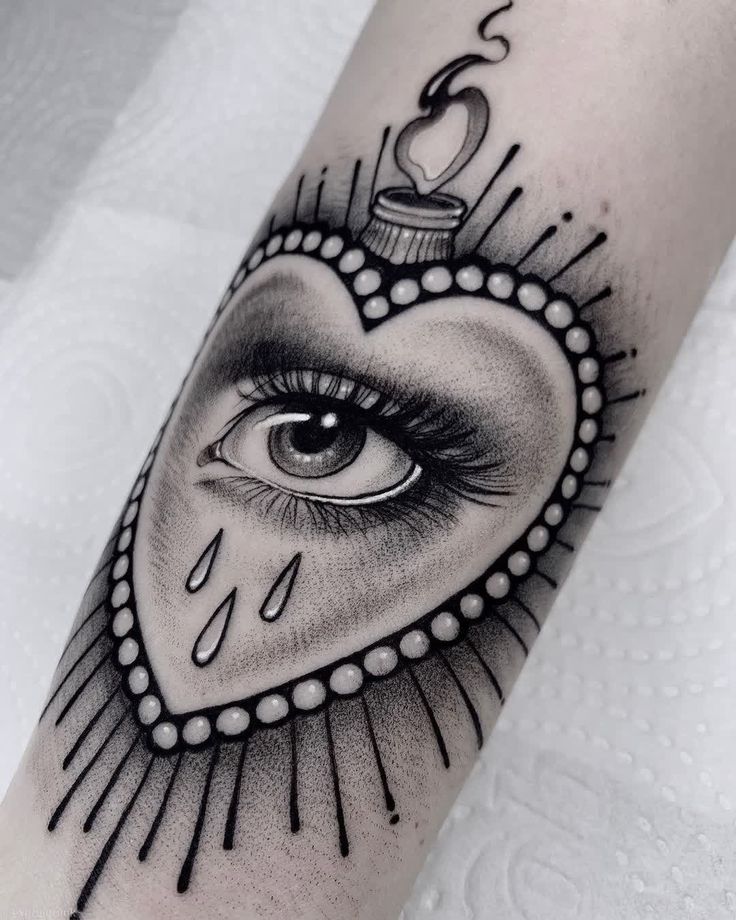 a heart with an eye inside it on the arm