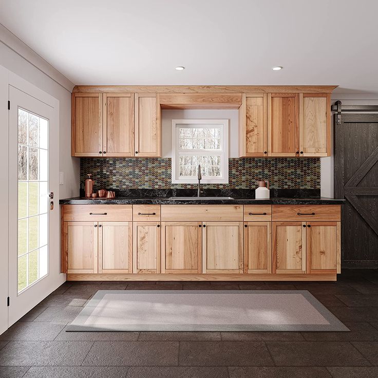 a kitchen with wooden cabinets and black counter tops in the middle of an open floor plan