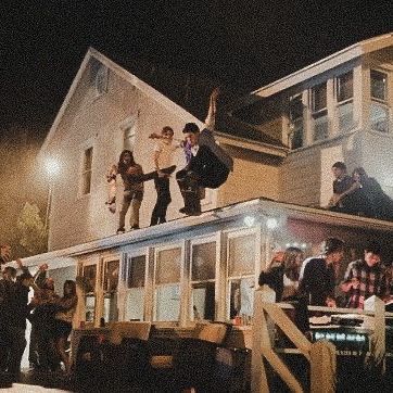 people standing on the roof of a house at night