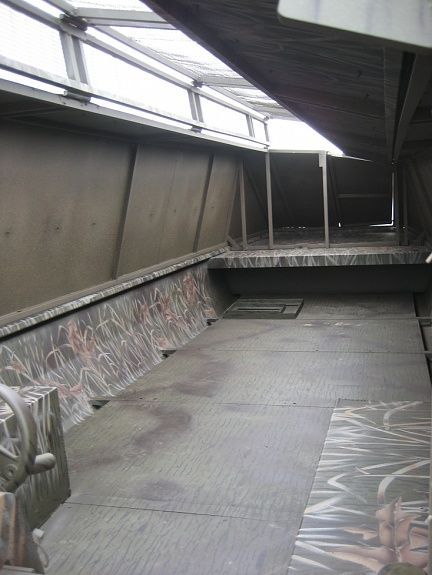 an empty skateboard park with graffiti on the walls